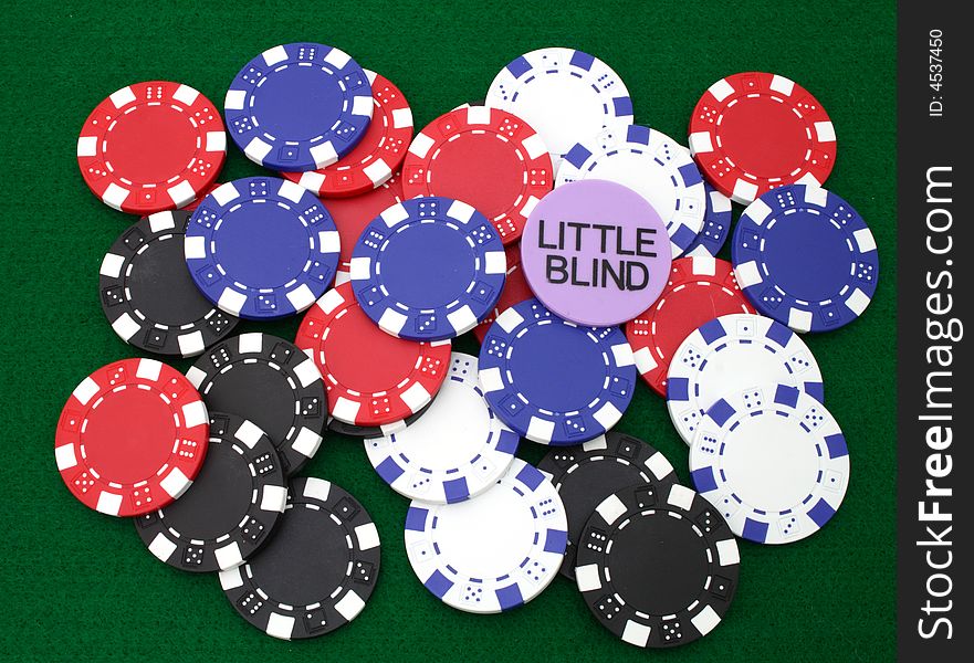 Colorful gambling chips over a green table. Colorful gambling chips over a green table