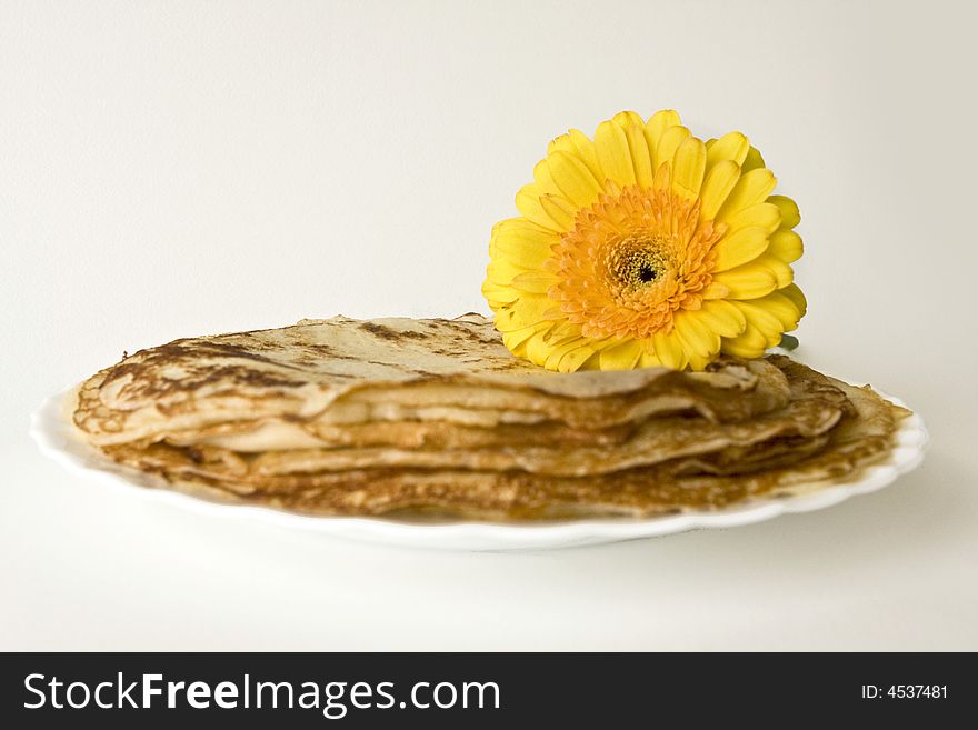 Russian pancakes with a yellow flower