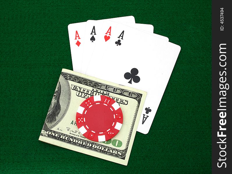 Four aces and money over a green table
