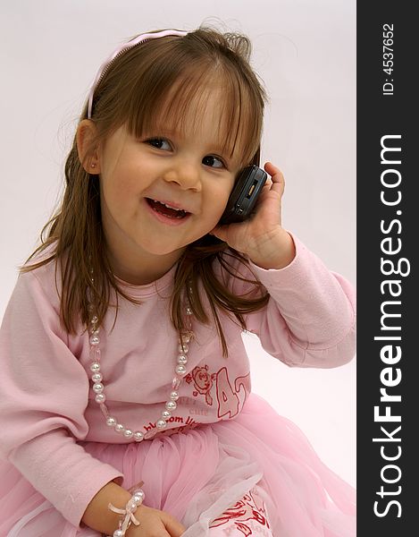 Cute little girl calling with a cellphone. Cute little girl calling with a cellphone