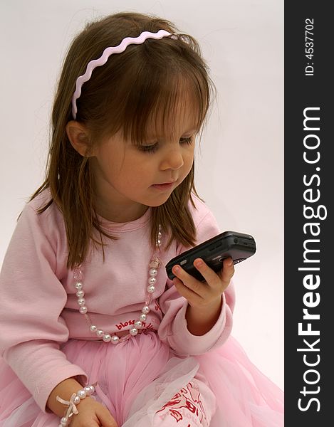 Cute little girl getting a tekst message on her cellphone. Cute little girl getting a tekst message on her cellphone