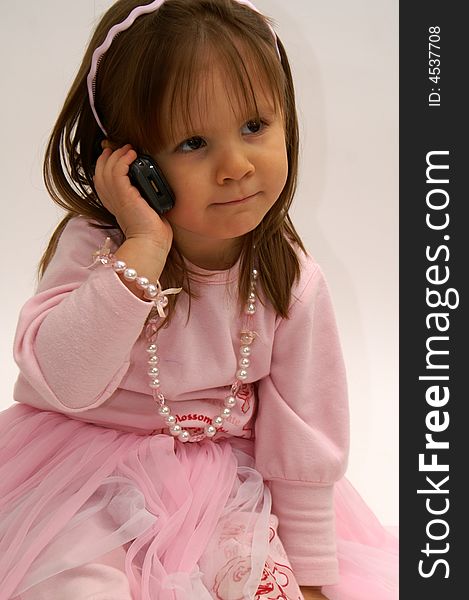 Cute little girl calling with a cellphone. Cute little girl calling with a cellphone