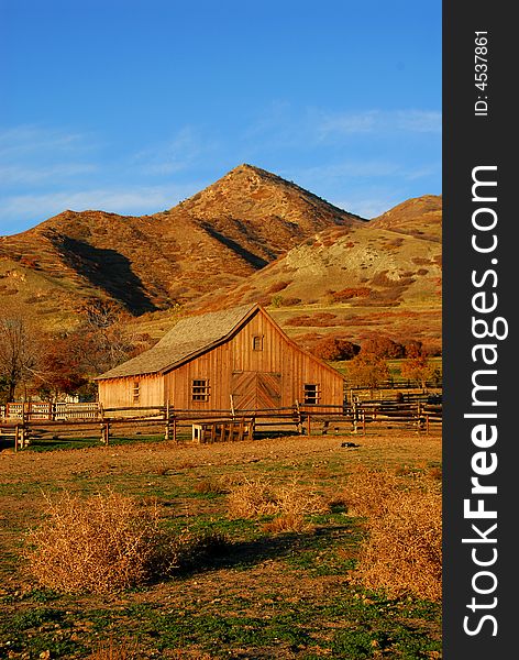 Wooden barn and field at sunset. Wooden barn and field at sunset