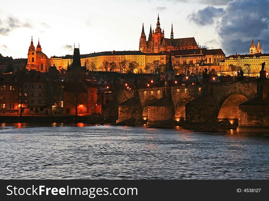 The magnificent Prague Castle at night along the River Vltava