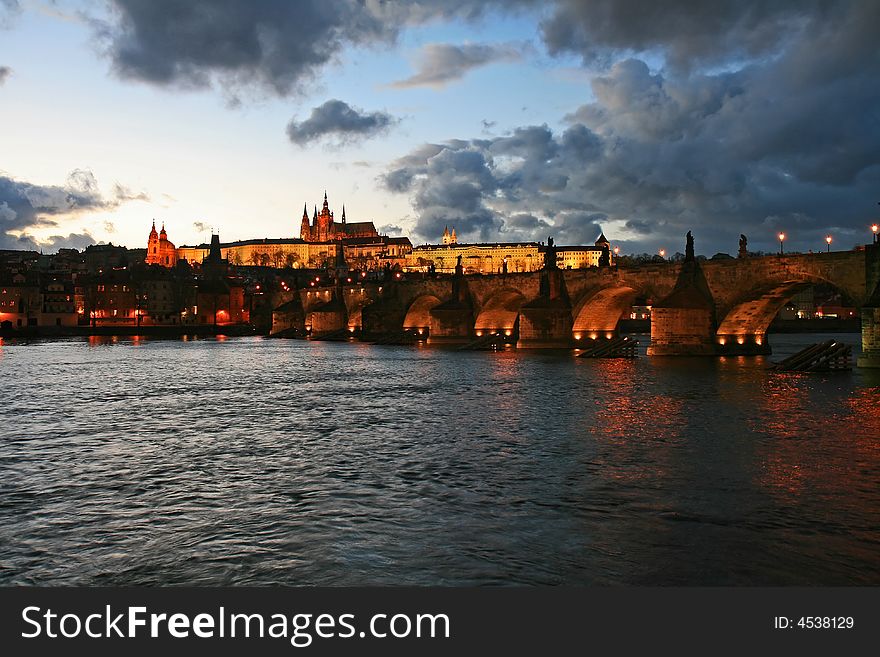 The magnificent Prague Castle at night along the River Vltava