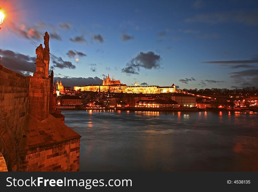 The magnificent Prague Castle at night along the River Vltava