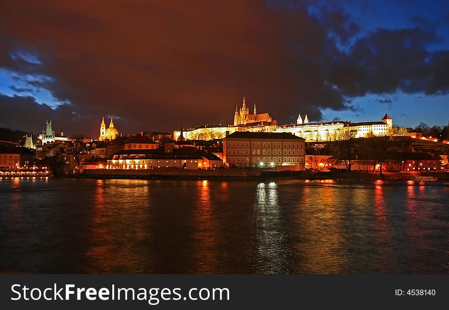 The magnificent Prague Castle at night along the River Vltava