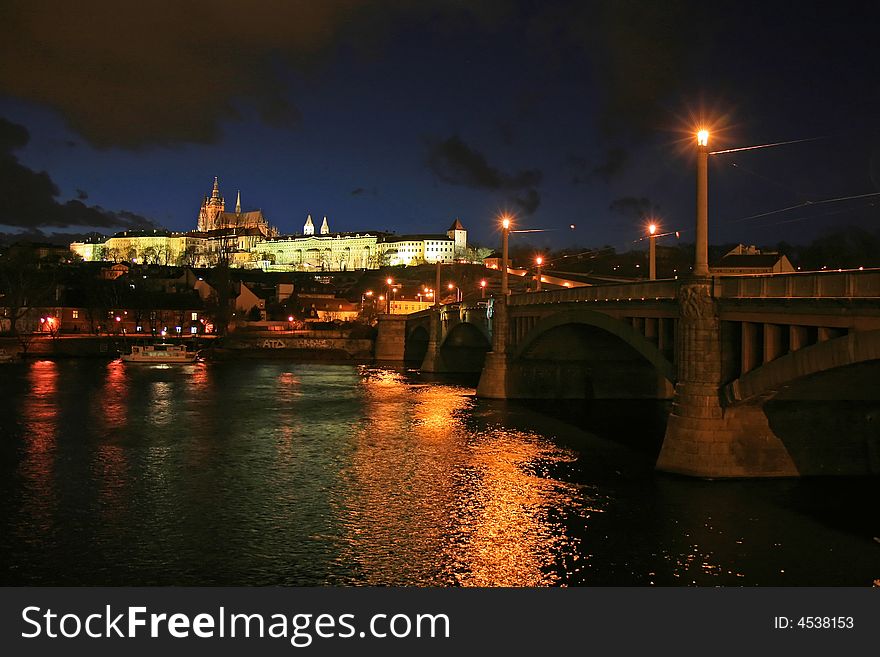 The magnificent Prague Castle at night along the River Vltava