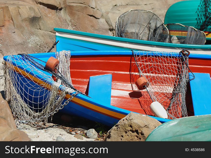 Small, colorful fishing boats pulled onto shore.