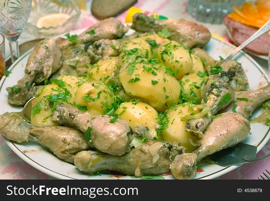 Photo of plate full of fried potatoes and chicken legs