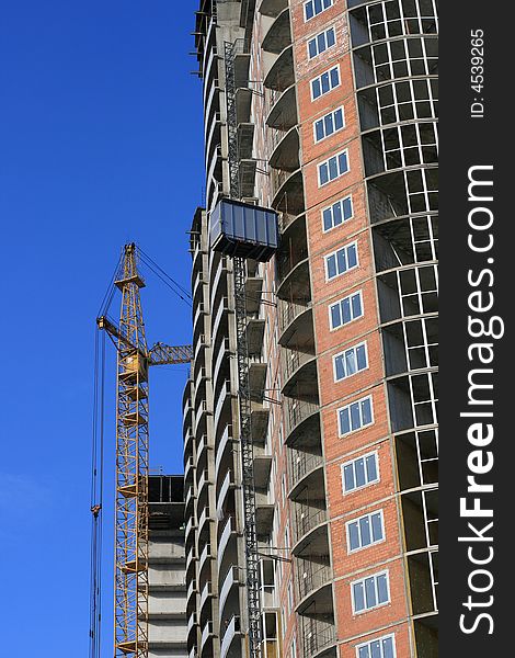 A under construction house on a background of the blue sky