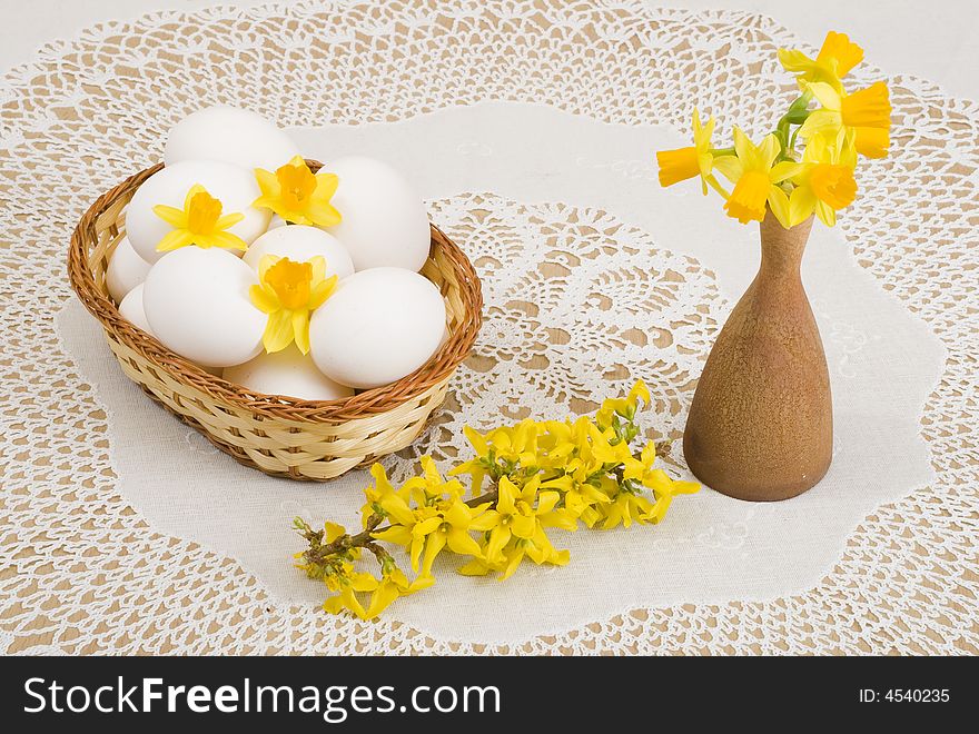 A basket of eggs, forsythia and yellow daffodils. A basket of eggs, forsythia and yellow daffodils