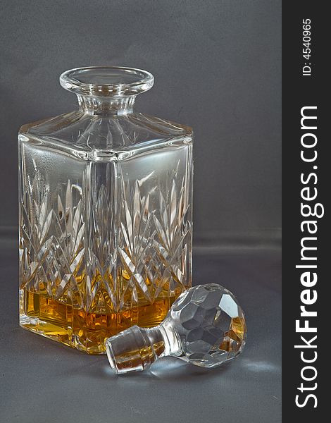 Whiskey in a crystal decanter with stopper. Whiskey in a crystal decanter with stopper