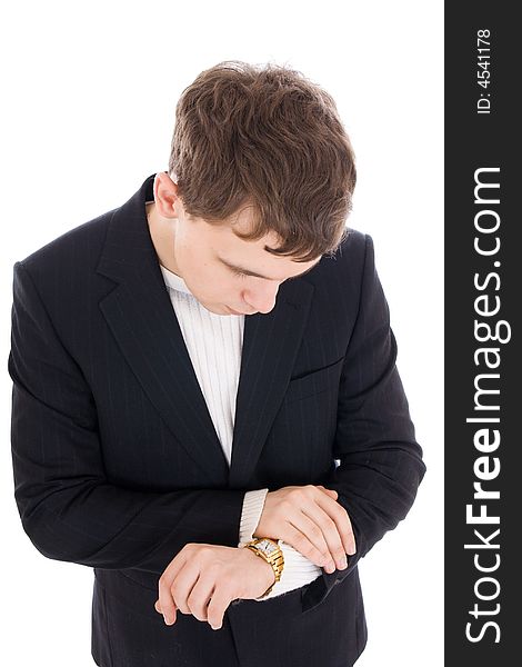 The young businessman looks at a watch isolated on a white background. The young businessman looks at a watch isolated on a white background