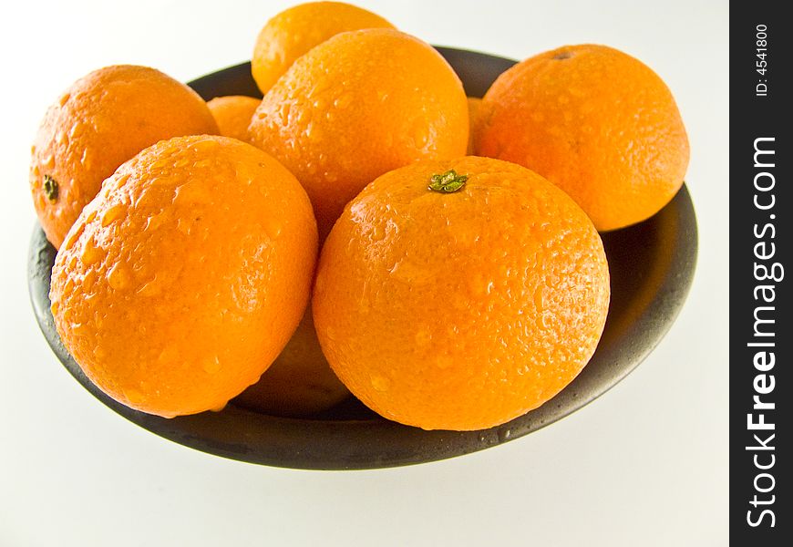 Healthy mandarines on black plate