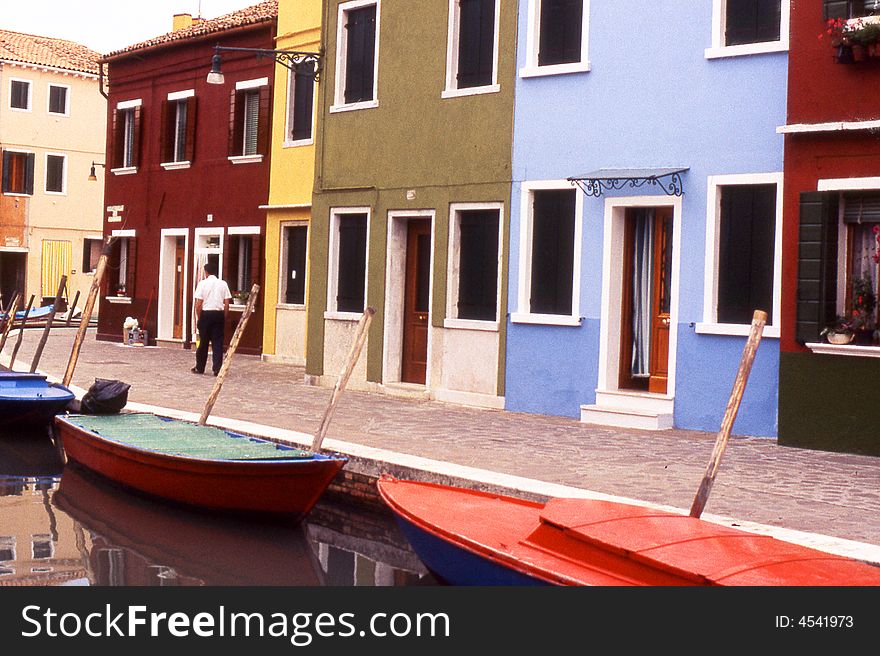 Boats moored in front of the colorful houses of Burano, Venice, Italy. Boats moored in front of the colorful houses of Burano, Venice, Italy.