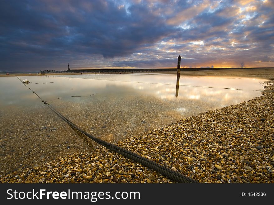 A small lake at the sea at sunset. A small lake at the sea at sunset