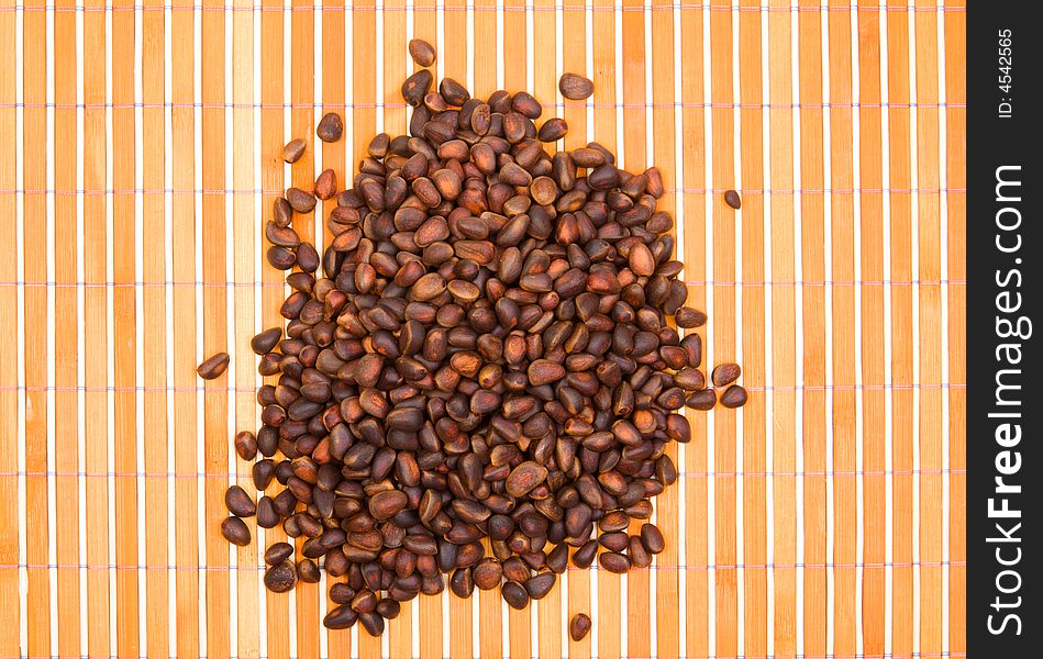 A pile of cedar nut on bamboo table-cloth