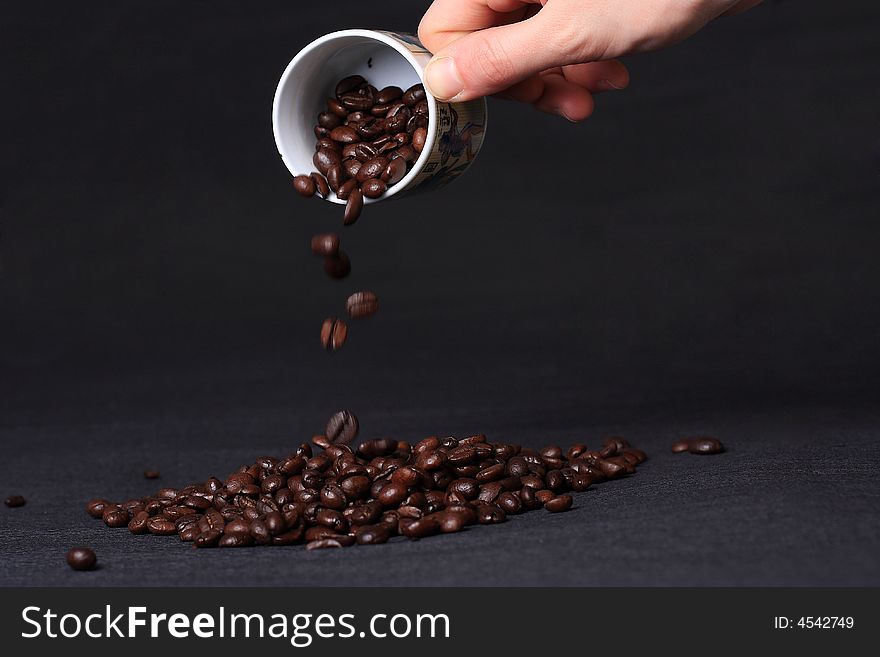 A mineral deposit of coffee is falling coffee grains. A mineral deposit of coffee is falling coffee grains