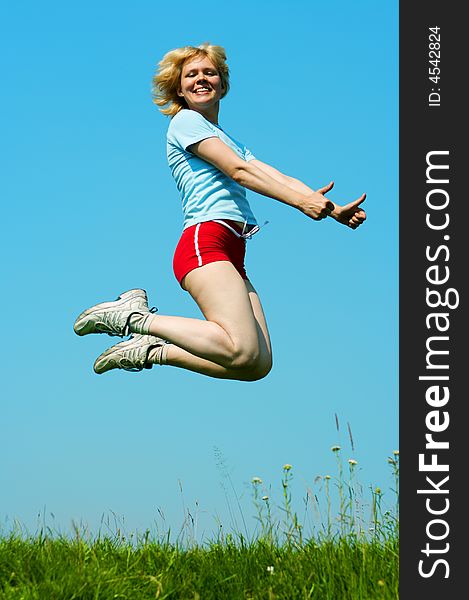 Woman jump outdoor under blue sky