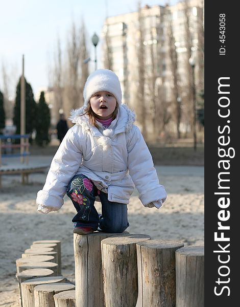 Merry child on playground, springtime