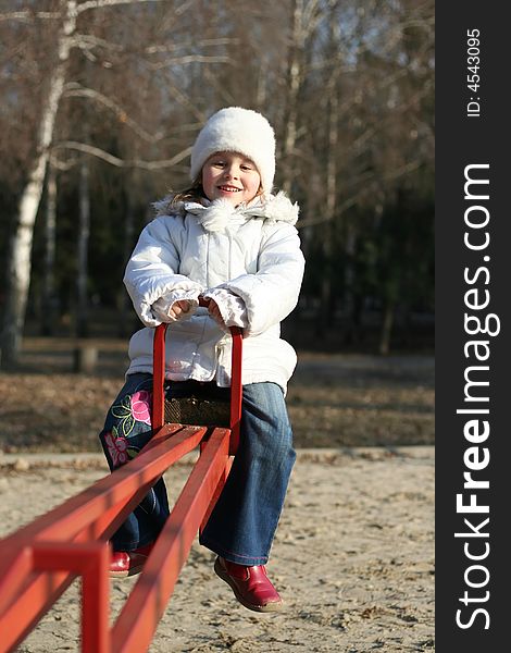 Merry child on playground, springtime