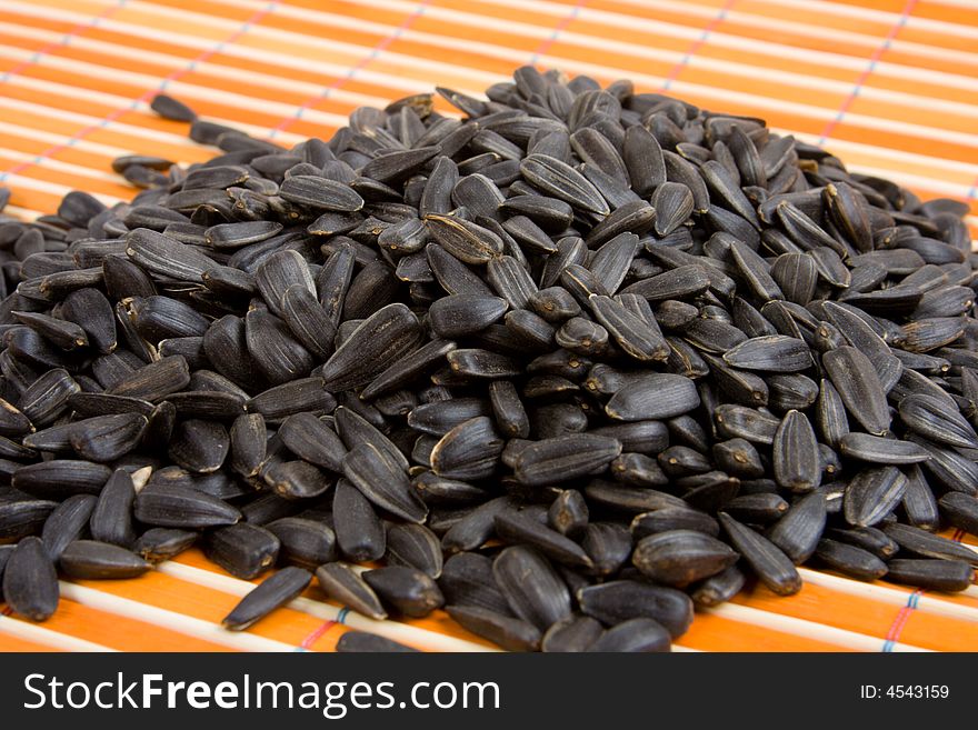 Close-up of sunflower seed on bamboo table-cloth