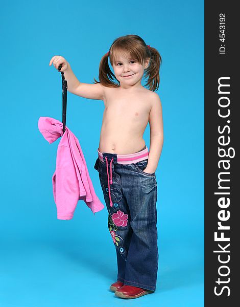 Child keeps clothes hanger, blue background
