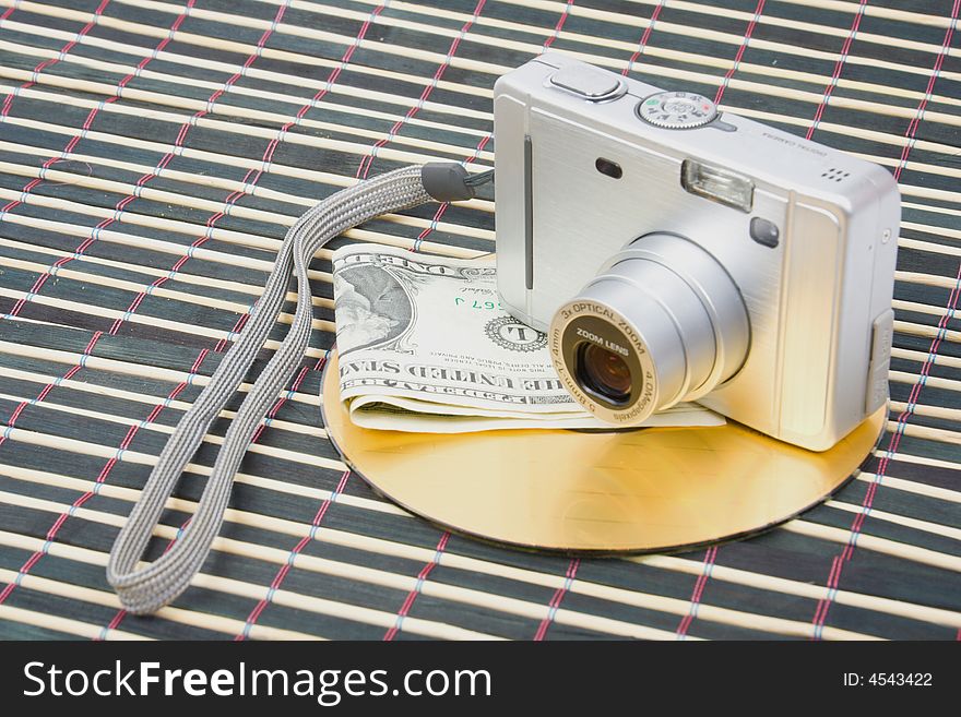 Us money and digital photo camera with dvd disk