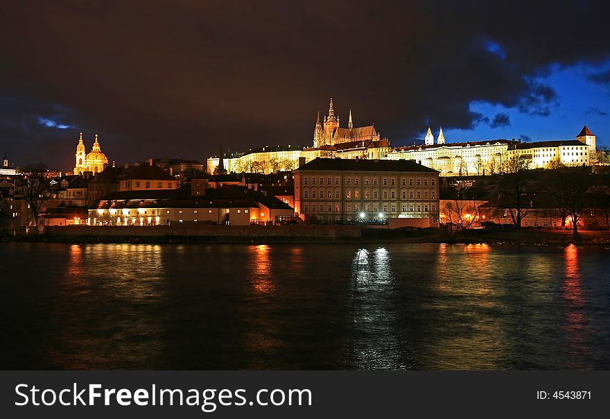 The magnificent Prague Castle at night along the River Vltava