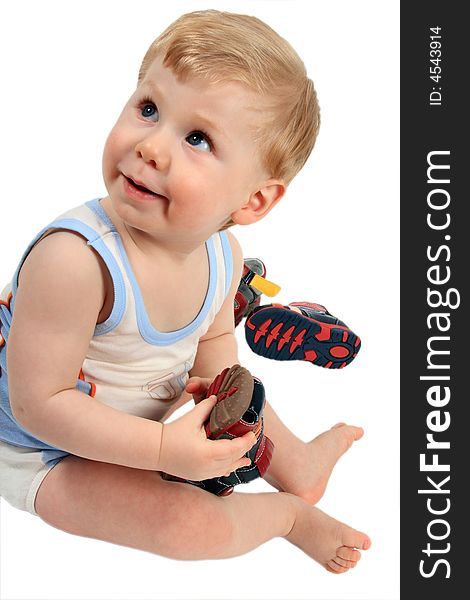 The beautiful little boy tries on footwear. The beautiful little boy tries on footwear