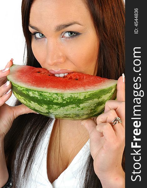 Beautiful brunette eating a melon isolated on white