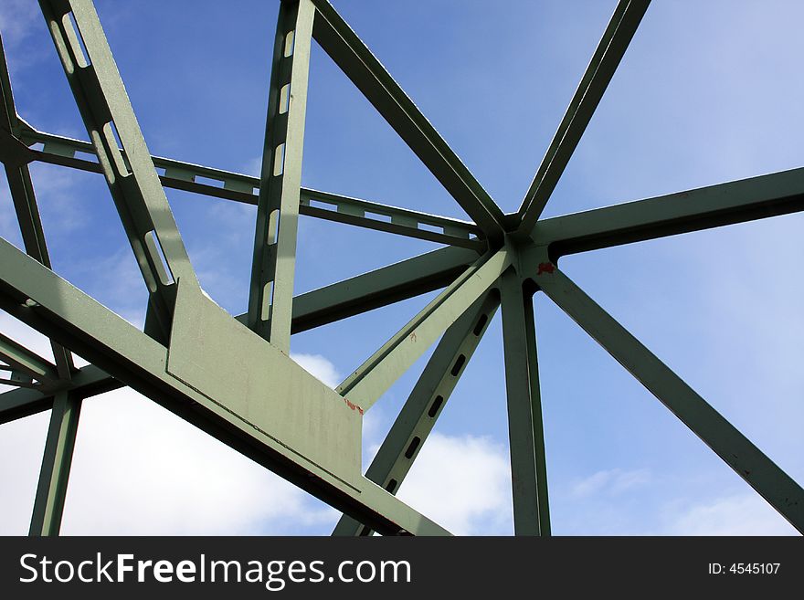 A bridge trestle creates a confusing maze under a blue sky. A bridge trestle creates a confusing maze under a blue sky.