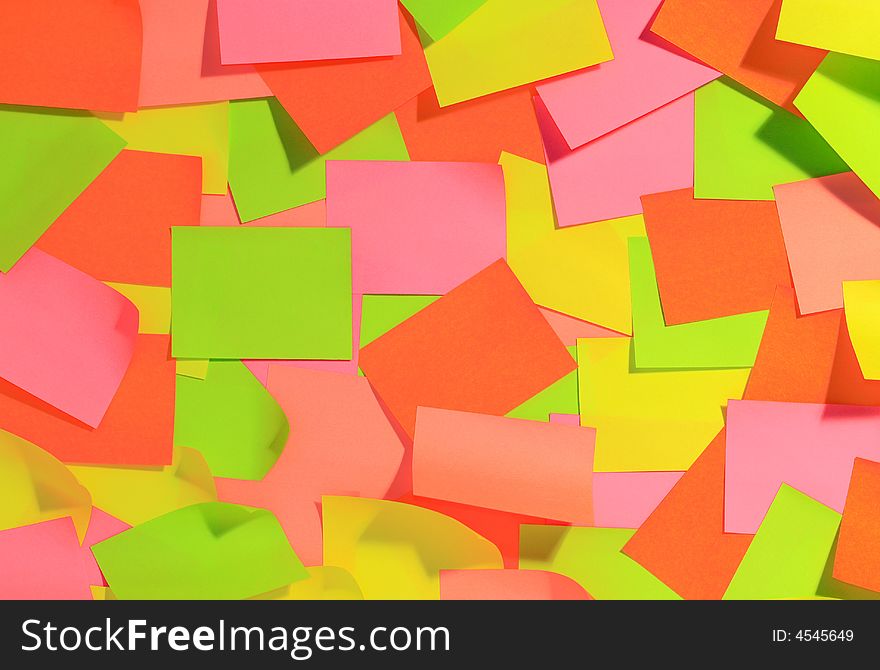 Desk, overfilled with empty sticky notes. Warm colours. Can be used for custom text or background. Desk, overfilled with empty sticky notes. Warm colours. Can be used for custom text or background.