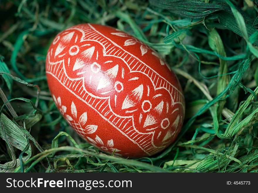 Handmade easter egg on the green hay. Shallow depth of field. Handmade easter egg on the green hay. Shallow depth of field.