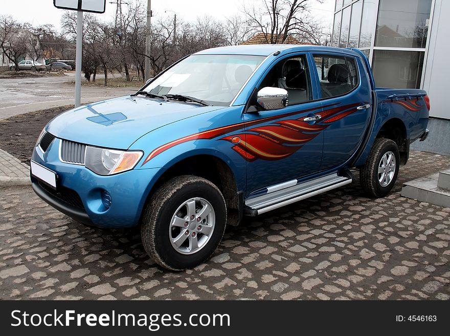 New blue pickup parked on stone pavement. New blue pickup parked on stone pavement