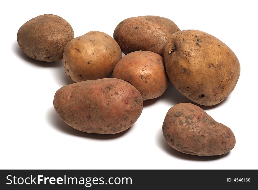 Several raw organic potatoes isolated on white background. Several raw organic potatoes isolated on white background