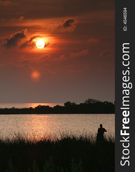 I saw this person fishing in the sound near Buxton, North Carolina on a summer evening. I saw this person fishing in the sound near Buxton, North Carolina on a summer evening.