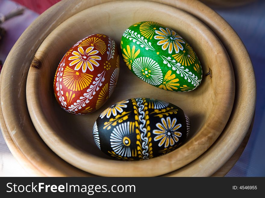 Easter eggs on the wooden plate