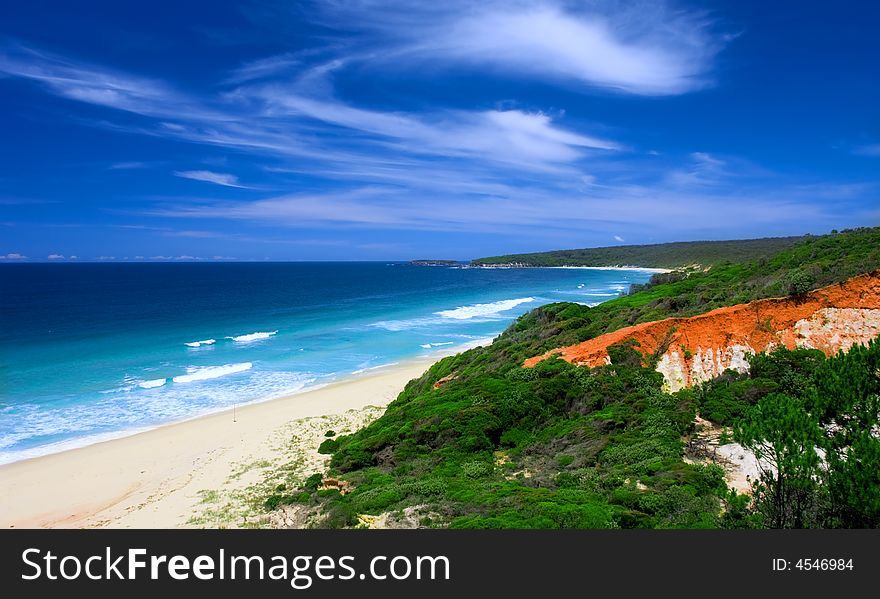 Vivid Red Cliffs on Unspoilt Beach