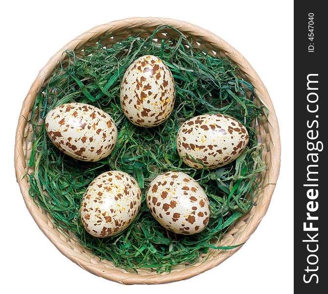 Basket with spotted eggs on the green hay. Clipping path included. Basket with spotted eggs on the green hay. Clipping path included.