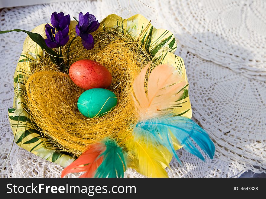 Easter eggs on the wooden plate