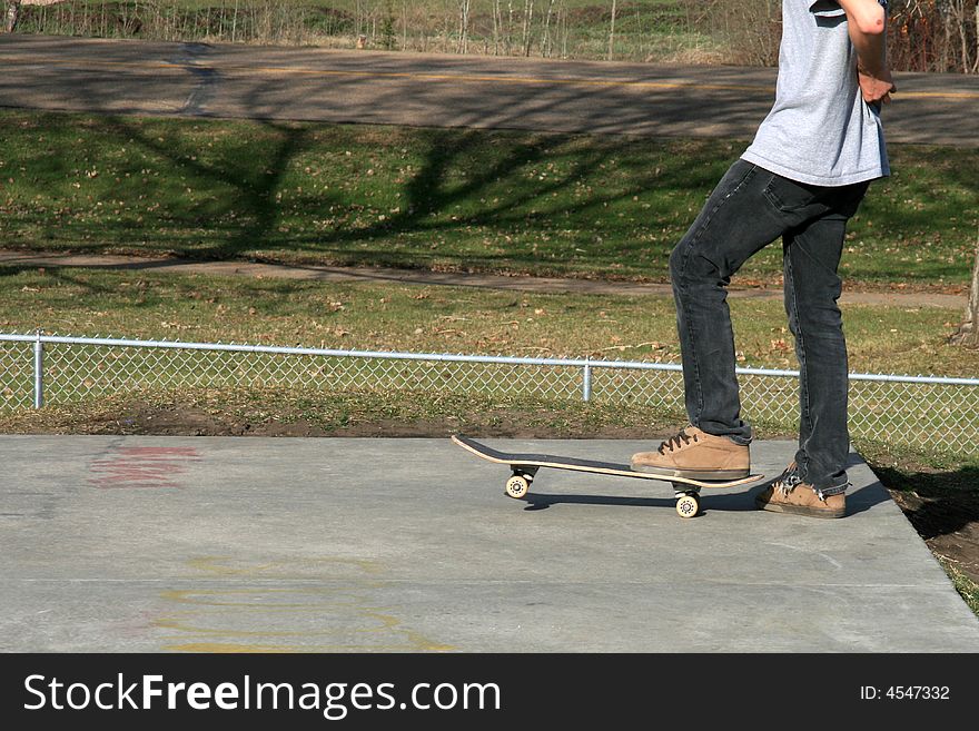 A skateboarder waiting to launch off a concrete ramp in a skatepark