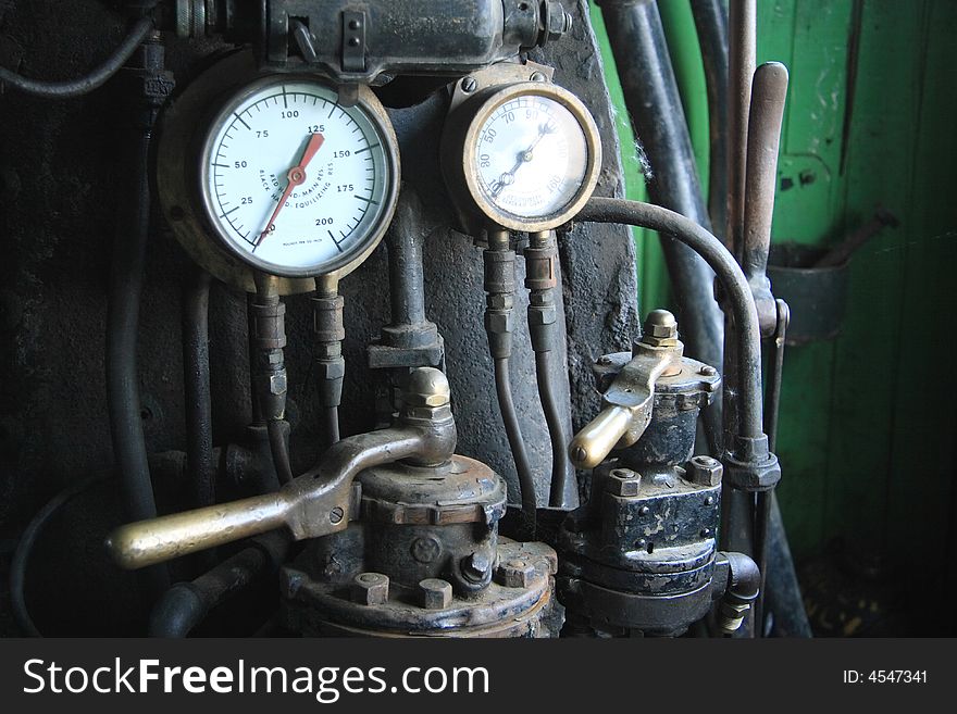 Close up detail of some pressure guages in an old vintage steam locomotive