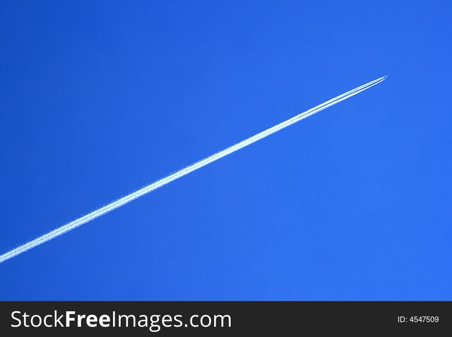 Vapour trail of a large jetliner streaking across a clear blue sky. Vapour trail of a large jetliner streaking across a clear blue sky