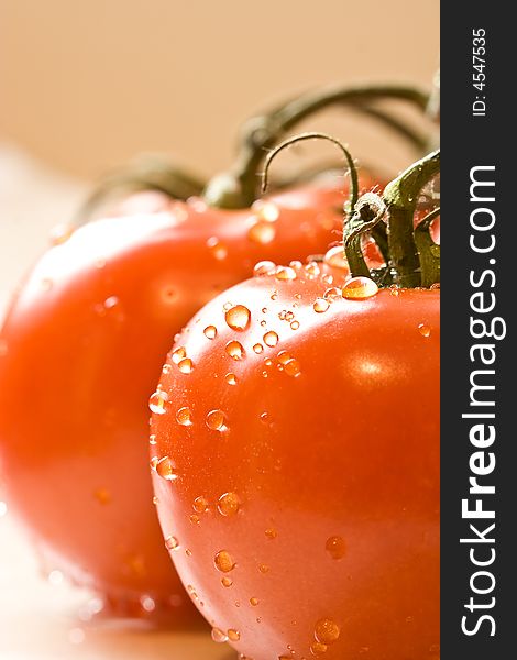 Fresh red ripe tomatoes with water drops shot with a macro lens. Fresh red ripe tomatoes with water drops shot with a macro lens