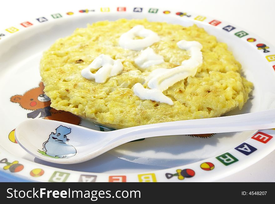 Children's breakfast. A baked pudding on a children's plate