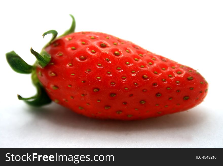 A brightly red strawberry on a white background