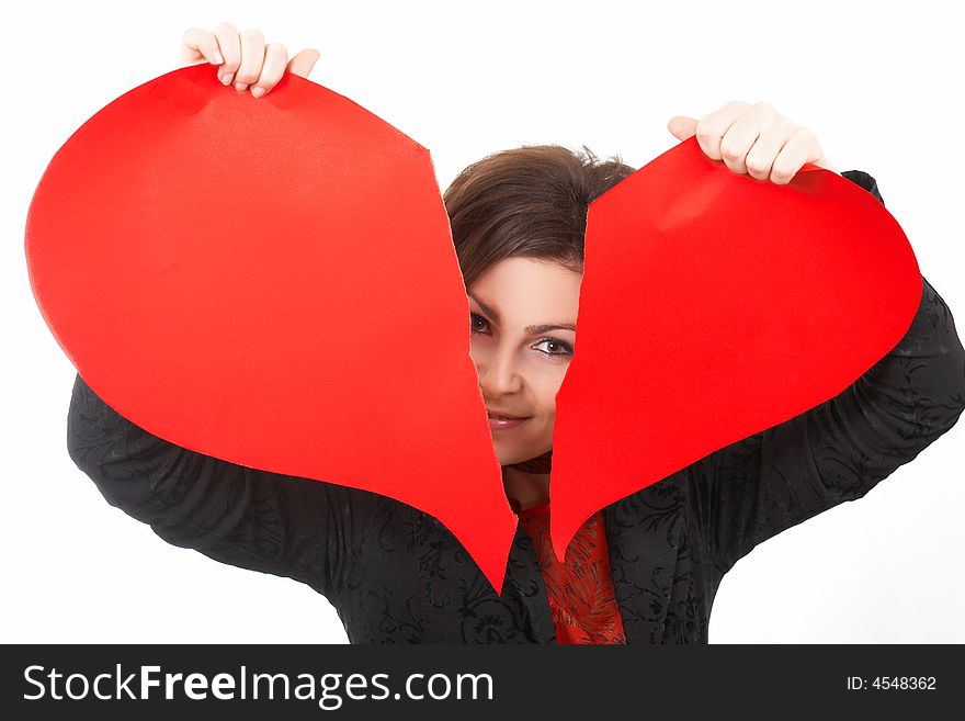 A smiling woman tearing a peper heart. A smiling woman tearing a peper heart