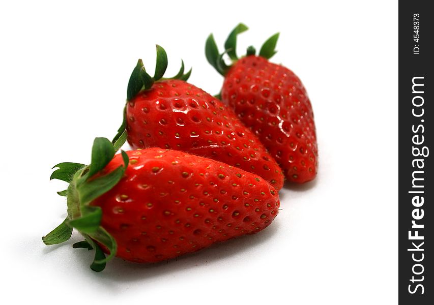 Three strawberries on a white background.